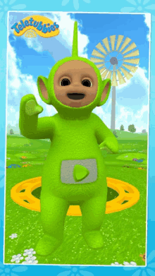 a green teletubbies character is standing in a field