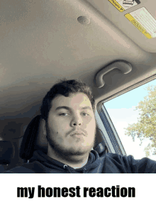 a man in a car with a warning sign on the roof