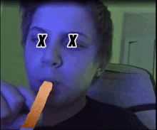 a person with two x 's on their eyes is eating a french fry