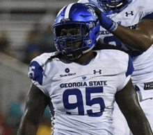 a georgia state football player wearing a white jersey with the number 95 on it