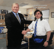 a man in a suit and tie shakes hands with another man in a white shirt