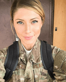 a woman in a u.s. air force uniform is smiling