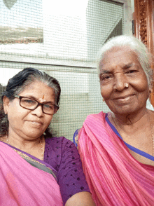 two women are posing for a picture and one has a nose ring on her nose