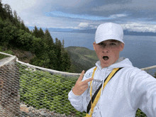 a man wearing a white hat and a white hoodie with the word ham on it takes a selfie