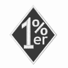 a black and white embroidered patch with the number 1 and the word % er .