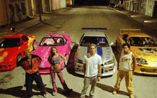 a group of people standing in front of cars with one man wearing a shirt that says engage on it