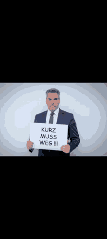 a man in a suit and tie is holding a sign that reads kurz muss weg