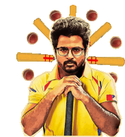 a man in a yellow shirt is surrounded by cricket balls and bats