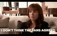 a woman is sitting on a couch and saying `` i don 't think the fans agreed '' .