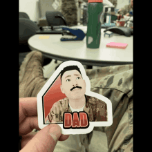 a sticker of a man with a mustache and the word dad on it