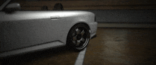 a silver car is parked in a dark garage