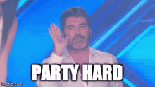 a man in a white shirt waves his hand in front of a blue background with the words party hard above him