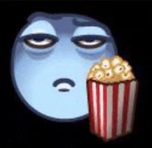 a blue smiley face is eating a bucket of popcorn .