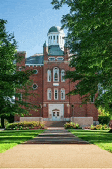 a large red brick building with a clock tower