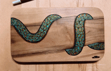 a wooden cutting board with a snake on it and the word soldier on the bottom