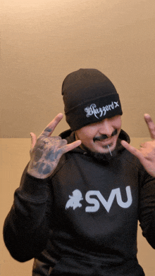 a man wearing a beanie and a hoodie that says svu