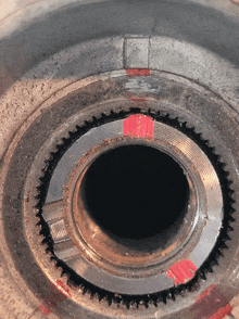 a close up of a metal ring with a red stripe on it