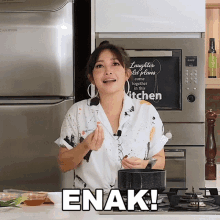 a woman cooking in front of a sign that says " laughter old plans come together in the kitchen "