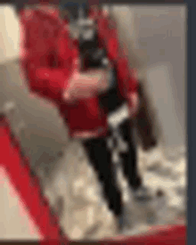 a blurry picture of a person in a red shirt walking down stairs