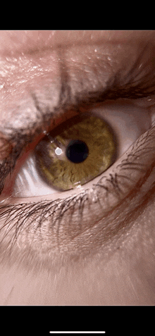 a close up of a person 's eye with a dark center