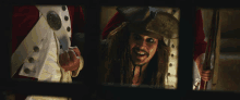 a man in a pirate costume is smiling and looking out a window