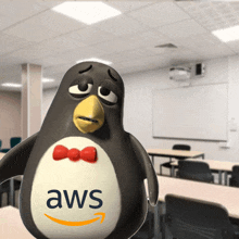 a penguin with an aws logo on its chest stands in a classroom