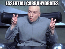 dr. evil is sitting in a chair and making a funny face with the caption essential carbohydrates