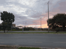 a sunset over a road with a sign that says ' a ' on it