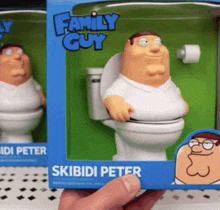 a person is holding a figurine of skibidi peter