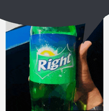 a person is holding a bottle of right soda in their hand