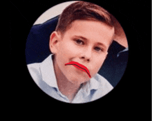 a young boy with a red line drawn on his mouth