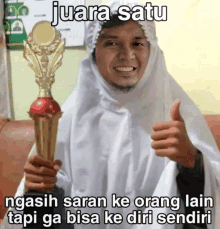 a man holding a trophy with the caption juara satu