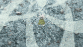 a cartoon character in a green skirt is standing on a rocky floor