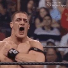 a man in a wrestling ring is screaming with his mouth wide open