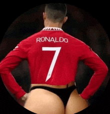 the back of a soccer player wearing a crop top with the number 7 on the back .