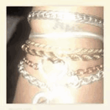 a close up of a woman 's wrist with bracelets on it