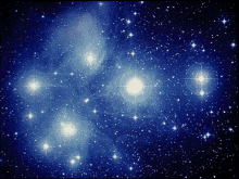 a cluster of stars in the night sky with a blue background