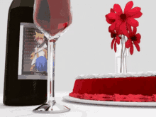 a bottle of wine next to a glass of wine and a cake with red frosting