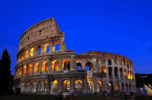 the colosseum is lit up at night in rome