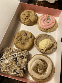 a box of cookies including a cinnamon roll