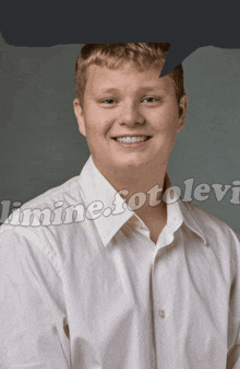 a boy in a white shirt is smiling in front of a sign that says ' limited fotolevi ' on it