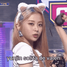 a girl wearing a cat ear headband with the words yunjin solita de valen written on it