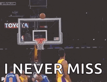 a basketball player in a lakers jersey is jumping in the air to catch a basketball in the net .