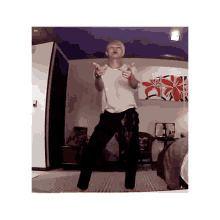 a man is dancing in a room in front of a purple ceiling .