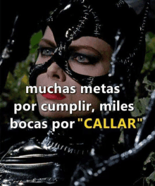 a woman in a catwoman costume with the words muchas metas por cumplir miles bocas por callar on the bottom