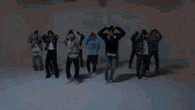 a group of young men are dancing in a foggy room in a video .