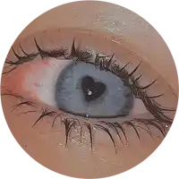 a close up of a person 's eye with a heart on it