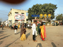 a group of people standing in front of a building with a sign that says naph