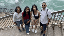 a group of people standing next to each other on stairs