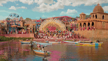 a group of boats are floating on a river in front of a large stage with a ferris wheel in the background